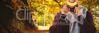 Composite image of portrait of man holding banana