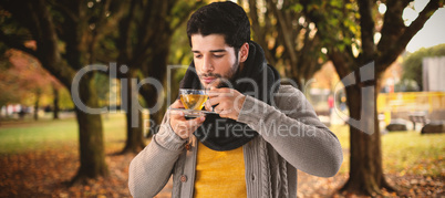 Composite image of young man having lemon tea