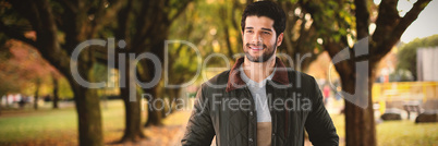 Composite image of smiling man with hands in pockets posing against white background