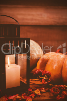 Pumpkins and candles on table during Halloween