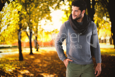 Composite image of smiling man posing with hand in pocket