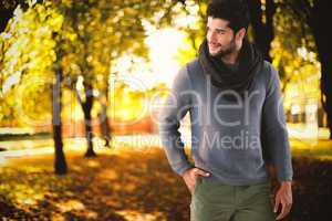 Composite image of smiling man posing with hand in pocket