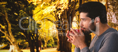 Composite image of side view of thoughtful young man having coffee