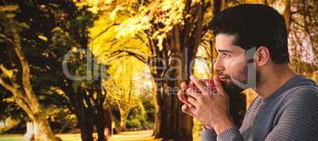 Composite image of side view of thoughtful young man having coffee