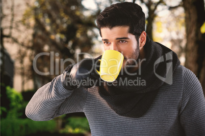 Composite image of thoughtful young man having coffee