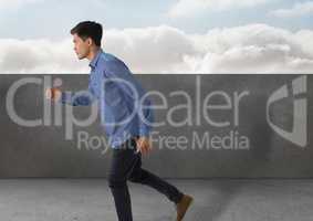 Businessman full body_Businessman running by stone wall and clouds