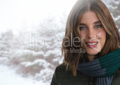 Woman wearing scarf in snow forest