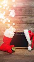 Santa hat and Christmas stocking arranged on slate