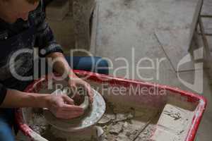 Male potter making a pot