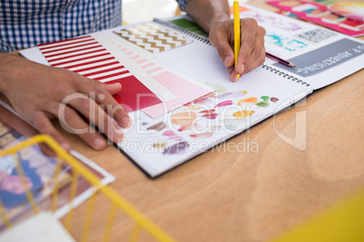 Male graphic designer working at desk