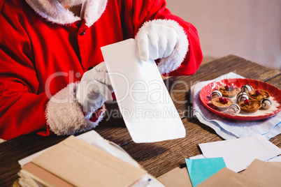 Santa Claus holding a letter