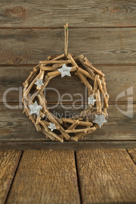 Christmas wreath hanging on wooden plank