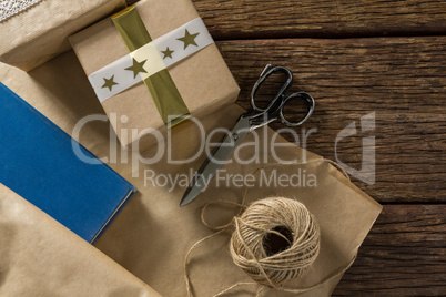 Paper with gift box by scissor and thread spool