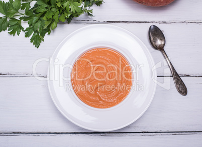 creamy pumpkin soup in a round white plate