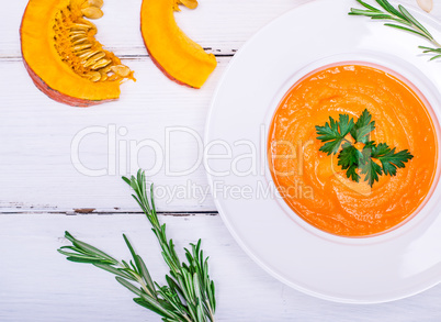 creamy pumpkin soup in a round white plate