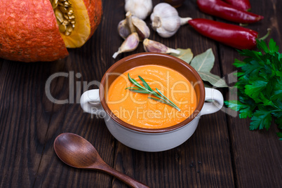 cream soup of fresh pumpkin in a ceramic plate