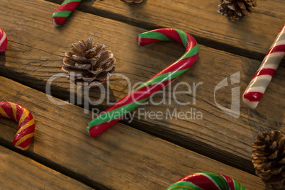 High angle view of candy canes and pine cones on table