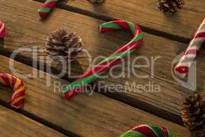 High angle view of candy canes and pine cones on table