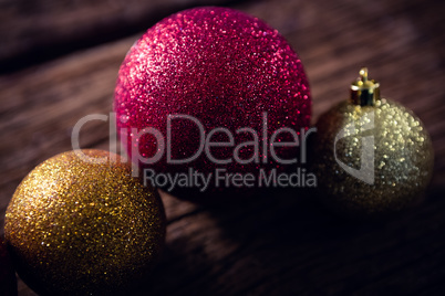 Christmas baubles on wooden plank