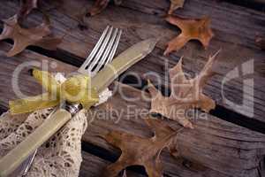 Tied knife and fork on wooden table