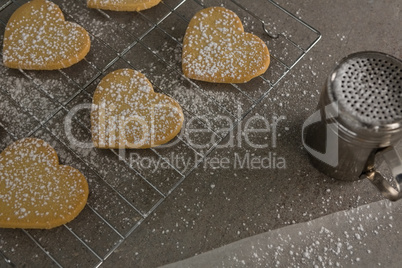 Raw heart shape cookies with sugar icing on baking tray