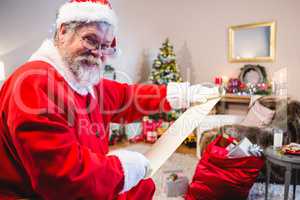 Santa Claus holding scroll in living room