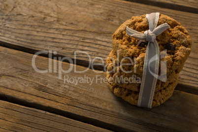 Close up of cookies tied with ribbon on wooden table