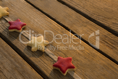 High angle view of star shaped cookies arranged on ribbon at table