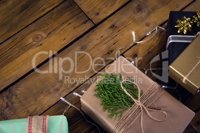 Gift boxes and christmas light on wooden plank