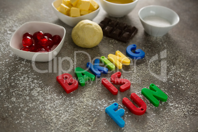 Various baking ingredients and alphabet forming baking is fun