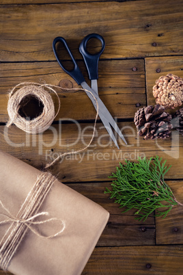 Fir, pine cone and wrapping materials on wooden table