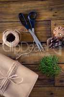 Fir, pine cone and wrapping materials on wooden table