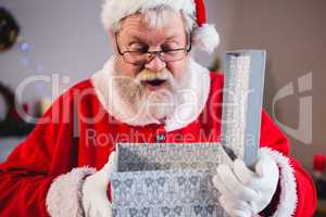 Santa claus opening a gift box