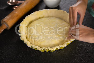 Woman pressing tart dough on mold