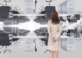 businesswoman standing in inverted office in the clouds