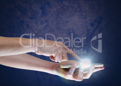 Hand touching phone with glow