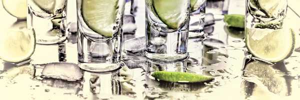 Selective focus. Gin tonic with lime wedges