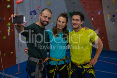 Trainer taking selfie with athletes in gym