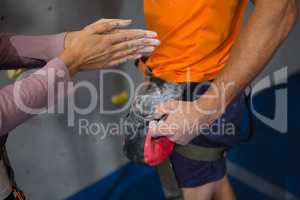 Cropped hand of woman taking chalk powder from trainer