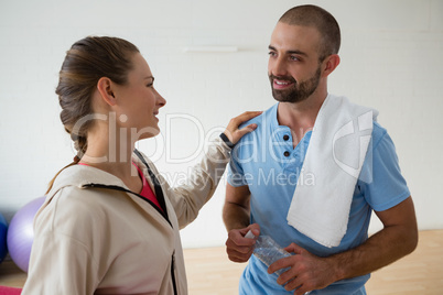 Student interacting with instructor in health club