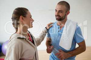 Student interacting with instructor in health club