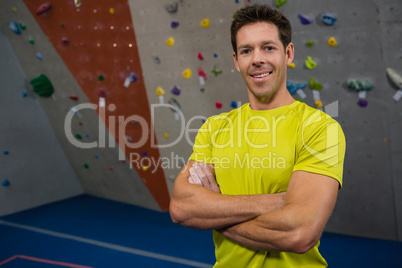 Portrait of athlete with arms crossed standing in health club