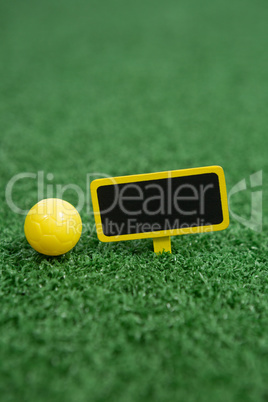 Football and mobile phone on artificial grass