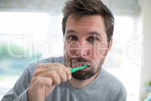 Man brushing teeth in the bathroom