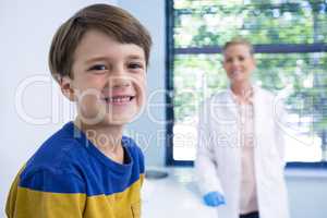 Portrait of smiling boy and dentist