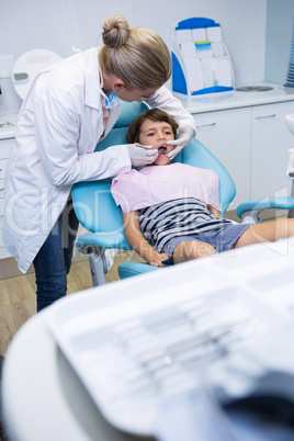 Female doctor examining boy