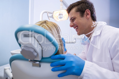 Dentist examining woman at clinic