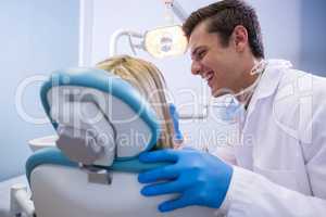 Dentist examining woman at clinic