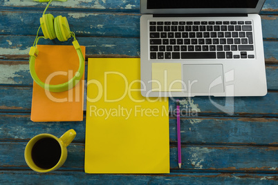 Black coffee and office accessories on wooden plank