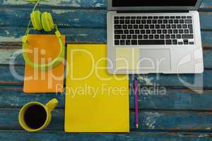 Black coffee and office accessories on wooden plank